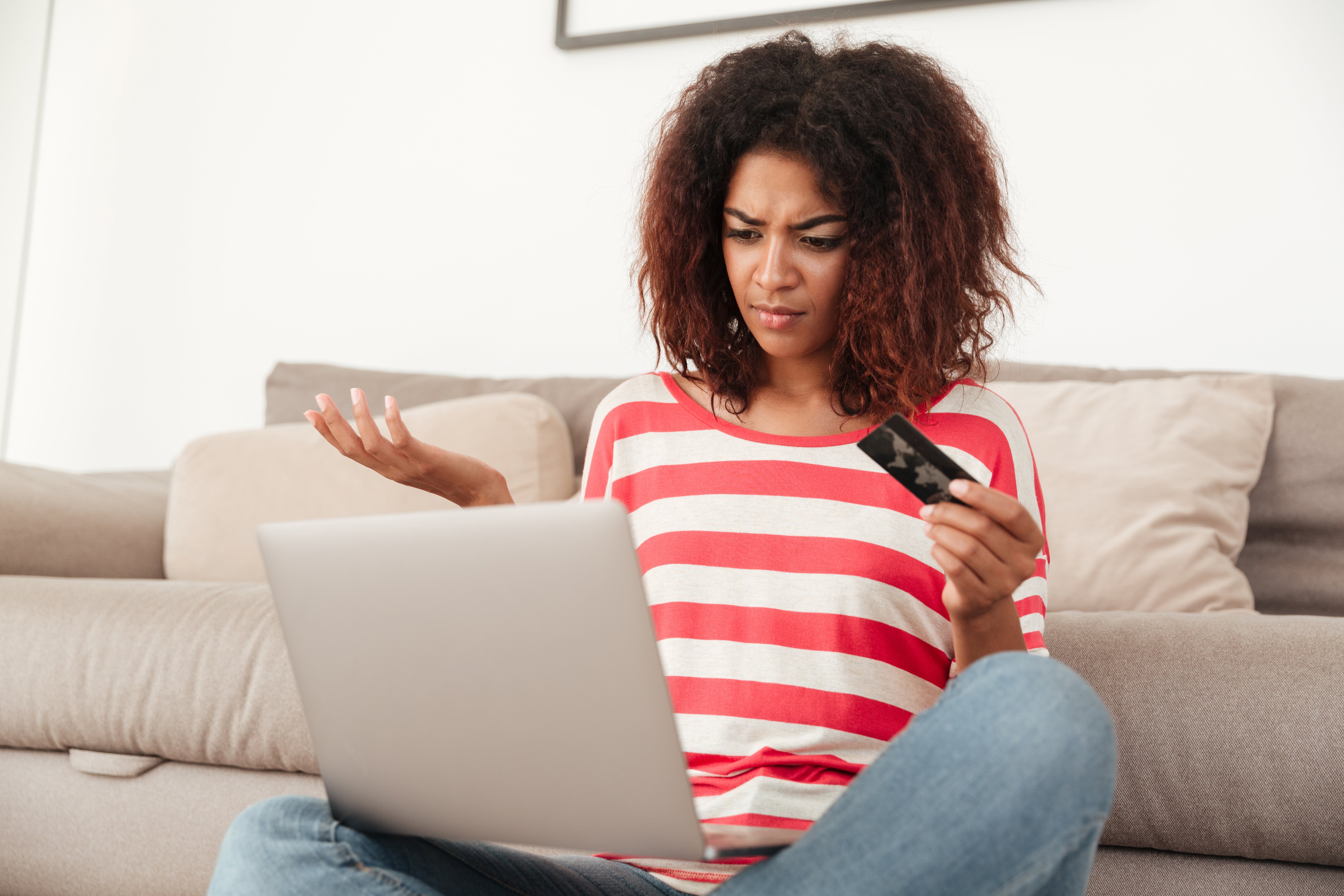 young-confused-upset-woman-using-laptop-home
